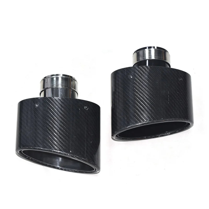 Two black carbon fiber exhaust tips with polished silver metal flanges, 