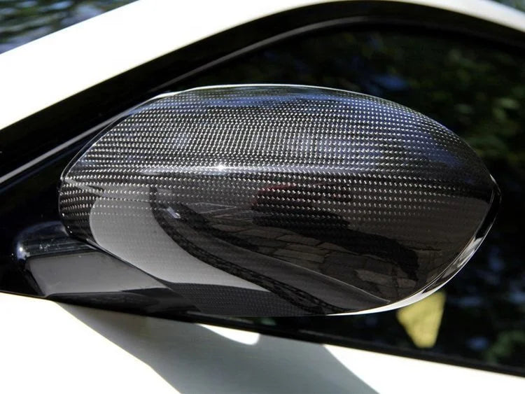 Carbon fibre side mirror cover installed on an Audi B9, close-up on white vehicle