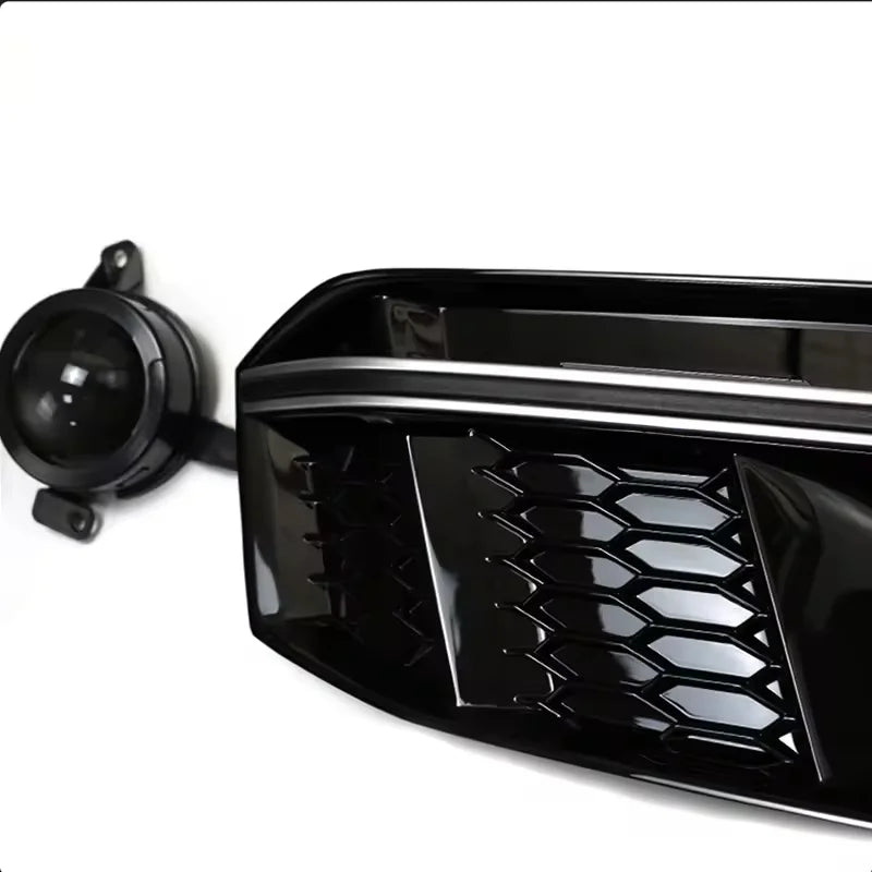 Close-up corner detail of RS4 style grille with fog light lens, silver trim