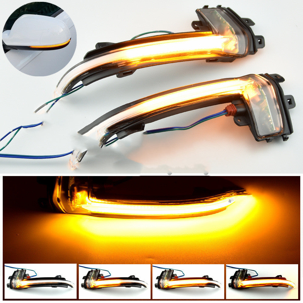 Close-up of Audi dynamic sequential mirror turn signal lit amber, showing sweeping LED strip and mirror install preview