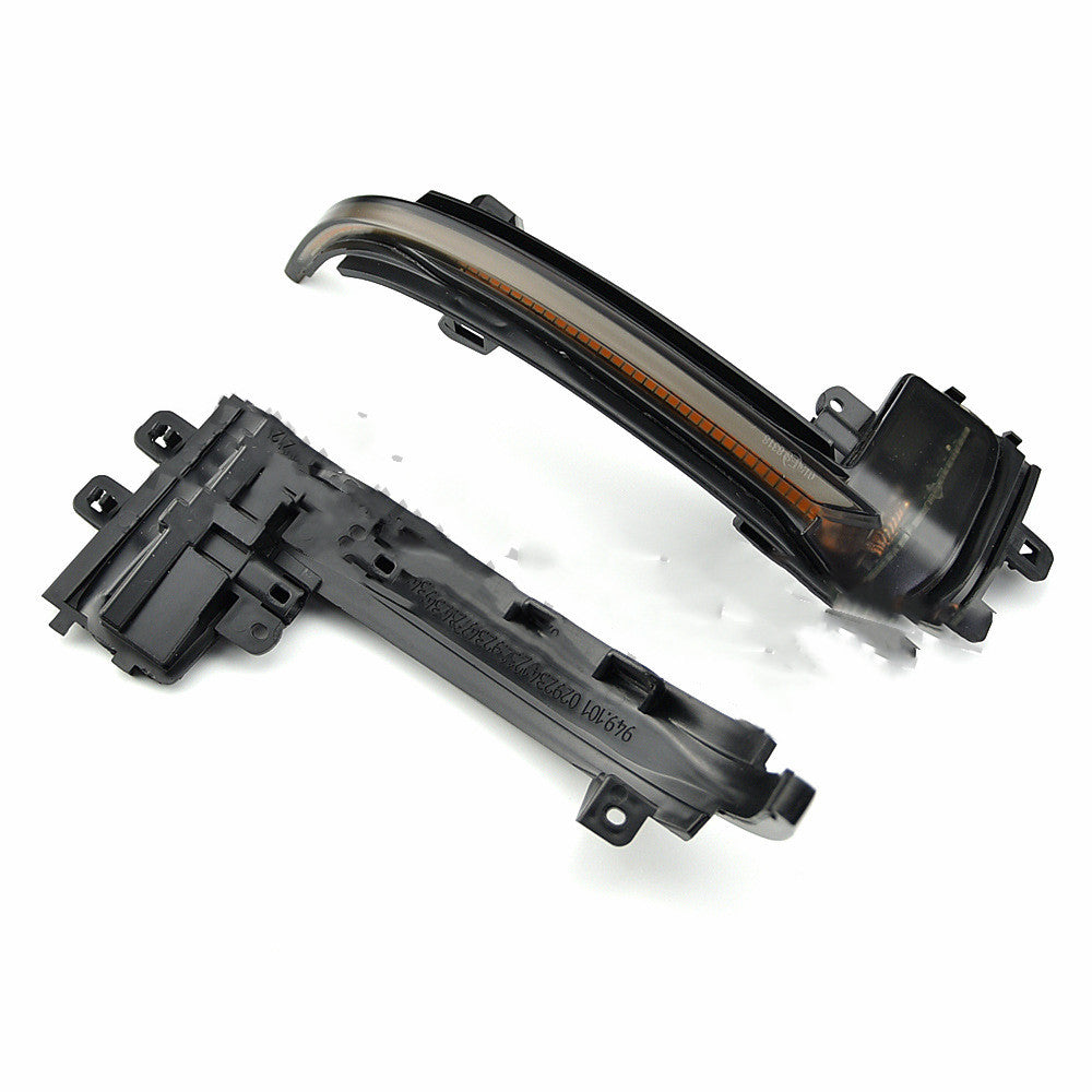 Unlit smoked lens dynamic sequential mirror turn signal pair for Audi with mounting bracket and connector visible