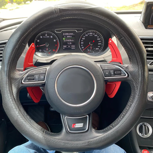 Red aluminium paddle shifter extensions installed on Audi S-Line steering wheel